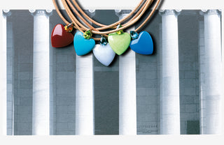 Necklace with colorful heart-shaped pendants against a gray architectural background