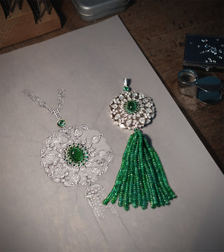 Pendant set with green emerald and diamond gemstones in the Fochtmann Studio.