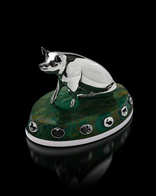 Decorative figurine of a pig on a green base with decorative elements