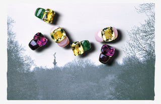 Multicolored ring and earrings gemstones on a textured white background